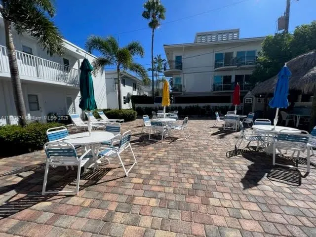 a patio with a table and chairs under an umbrella