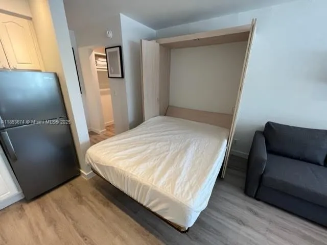 a bed sitting in a bedroom next to a window