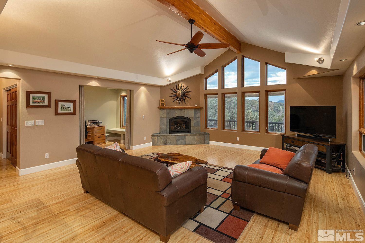 22010 Panhandle Road Reno, NV 89521 - Photo 3 of 32 a living room with furniture fireplace and a flat screen tv