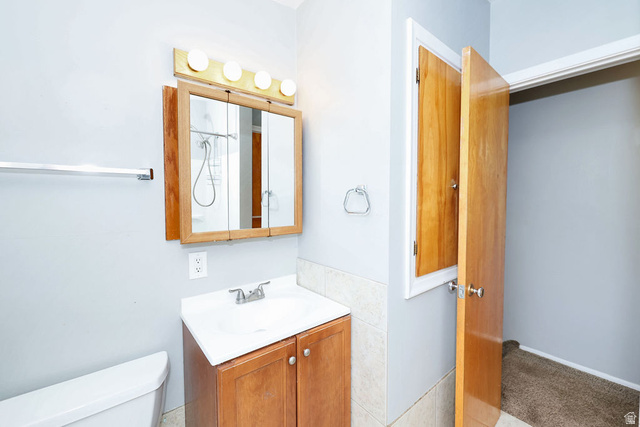 1272 Cook Street Ogden, UT 84404 - Photo 17 of 46 Bathroom with a wood-finish vanity and integrated sink