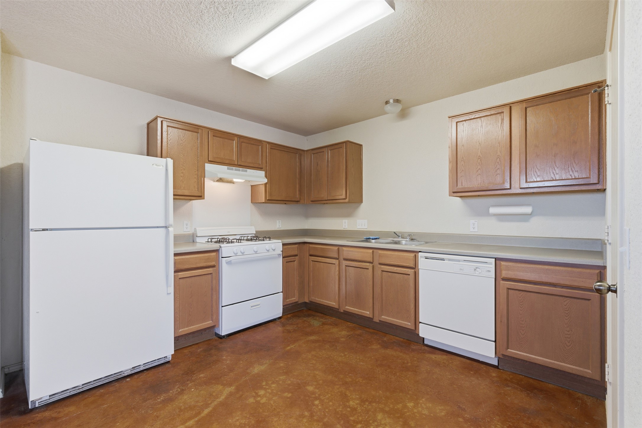 4529 Secure Lane, Unit 31 Austin, TX 78725 - Photo 13 of 38 a kitchen with stainless steel appliances granite countertop a refrigerator sink and stove