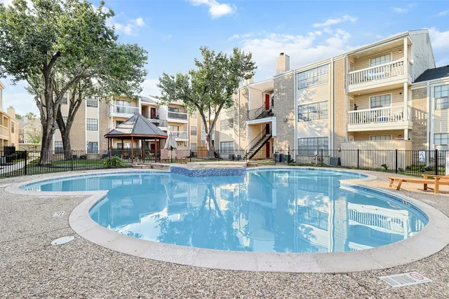 a view of a swimming pool with outdoor seating