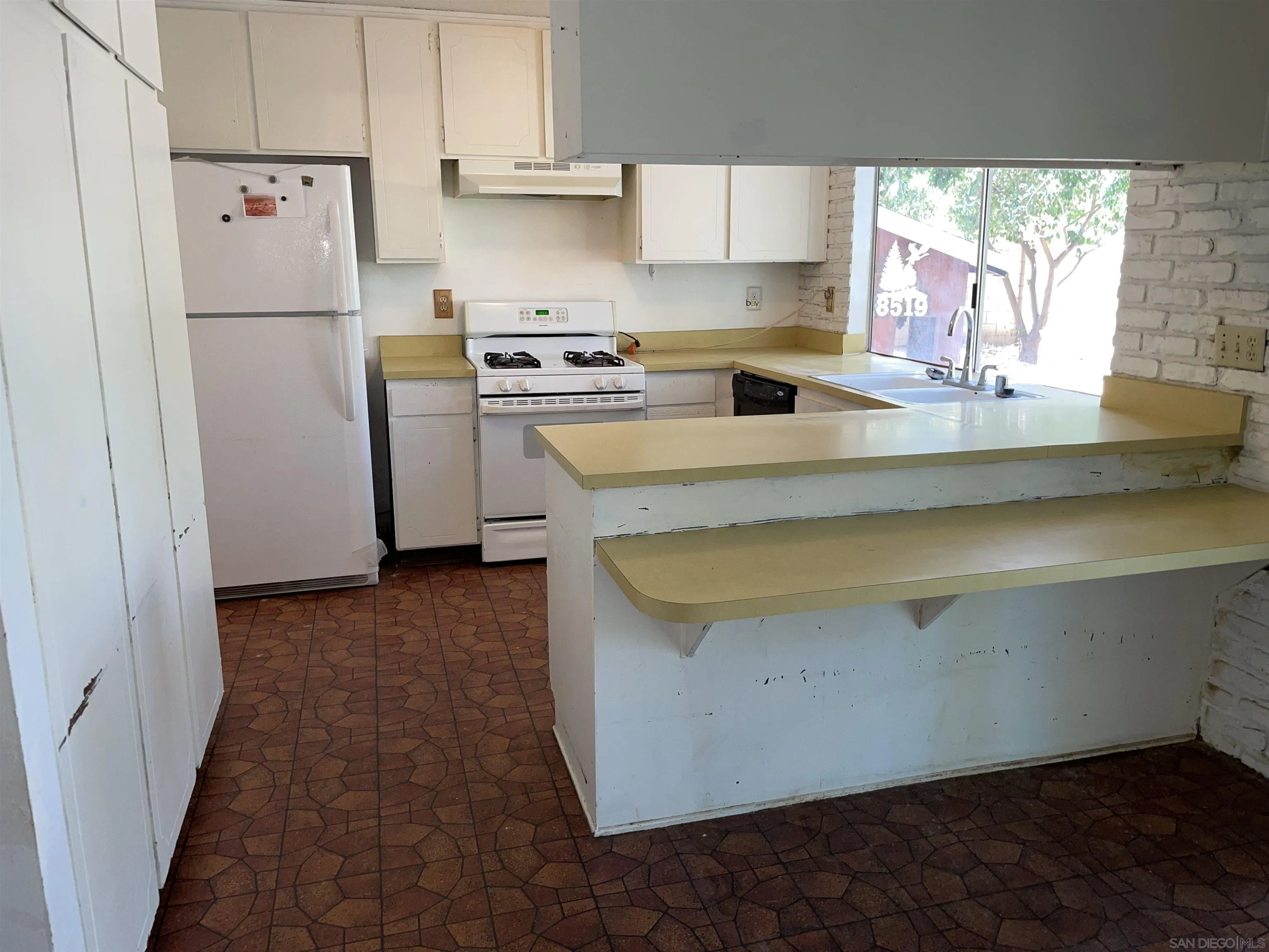 6005 Baldwin Avenue Riverside, CA 92509 - Photo 4 of 4 a kitchen with a refrigerator a stove a sink and a window