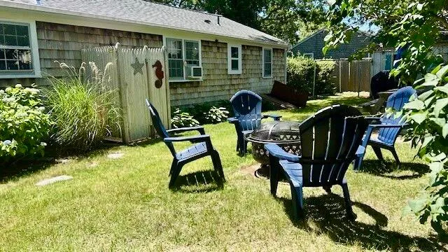 a view of a chairs and table in backyard of the house