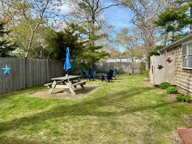 a view of a house with backyard and sitting area