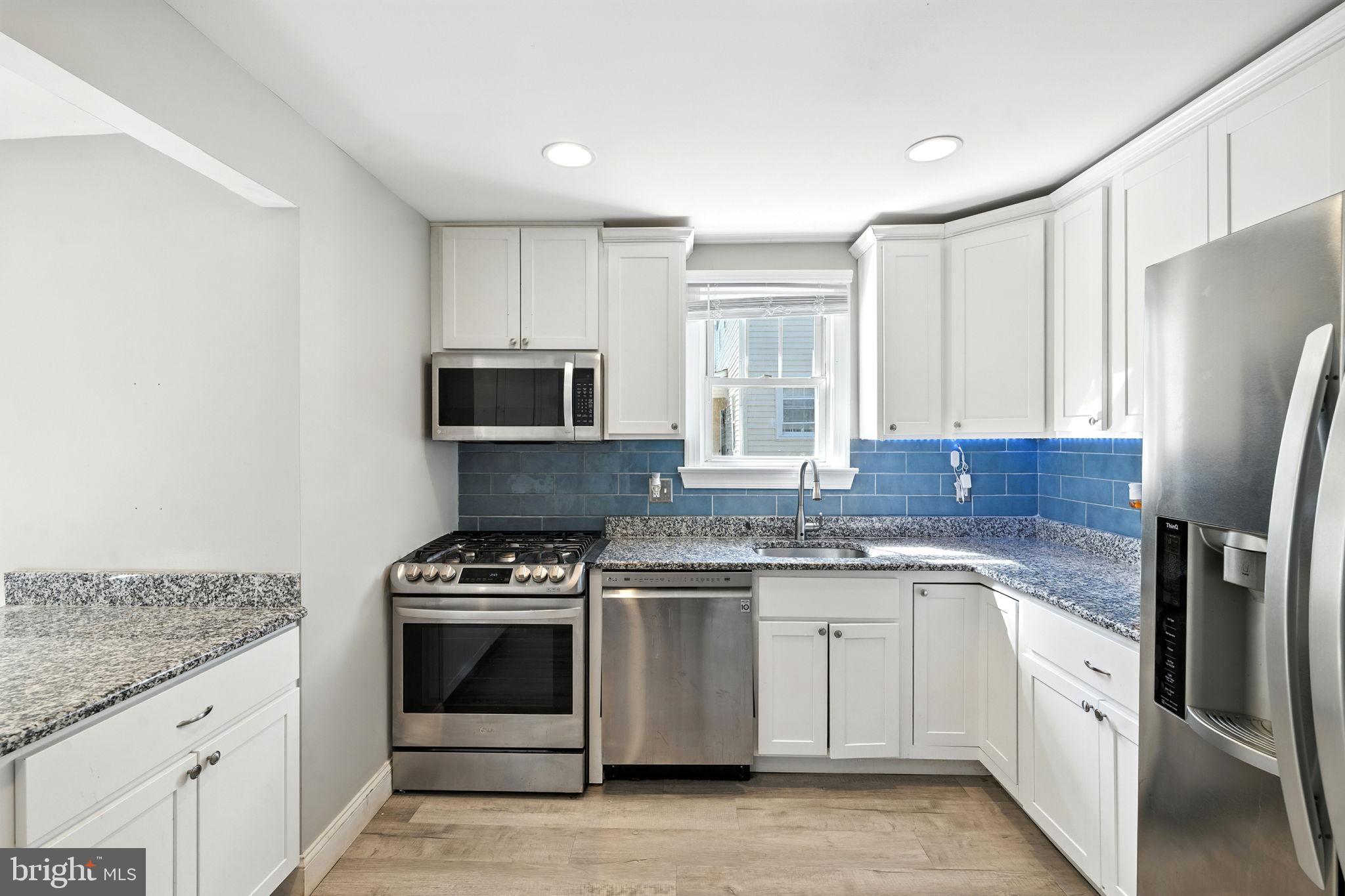 361 Savannah Road Baltimore, MD 21221 - Photo 13 of 30 a kitchen with stainless steel appliances granite countertop a stove a sink and a refrigerator