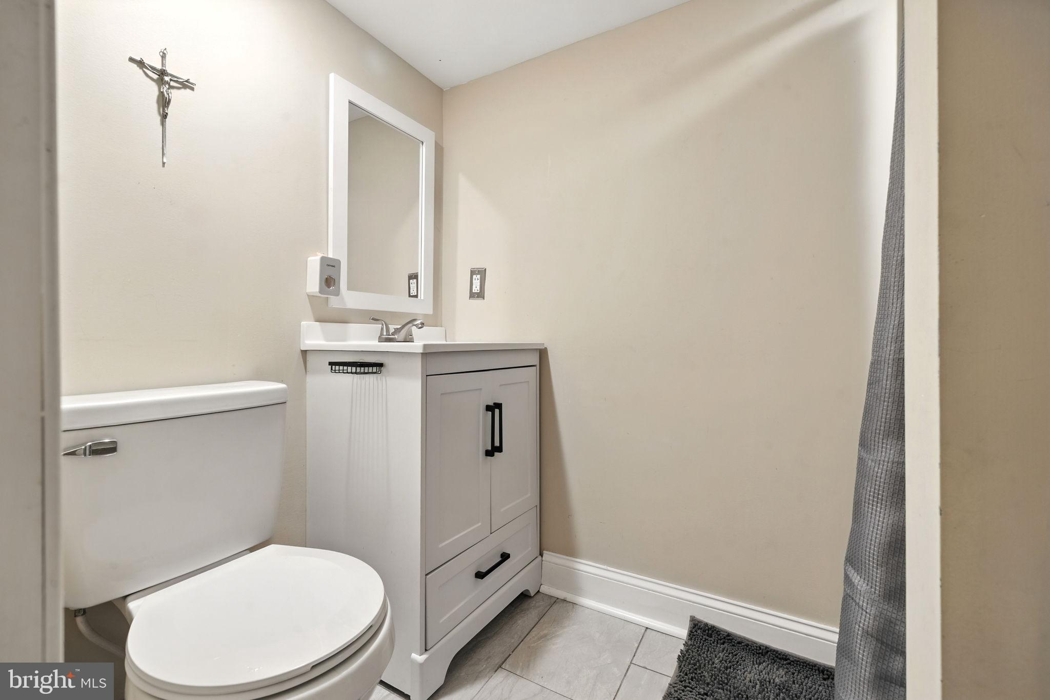 361 Savannah Road Baltimore, MD 21221 - Photo 19 of 30 a bathroom with a granite countertop toilet and a sink
