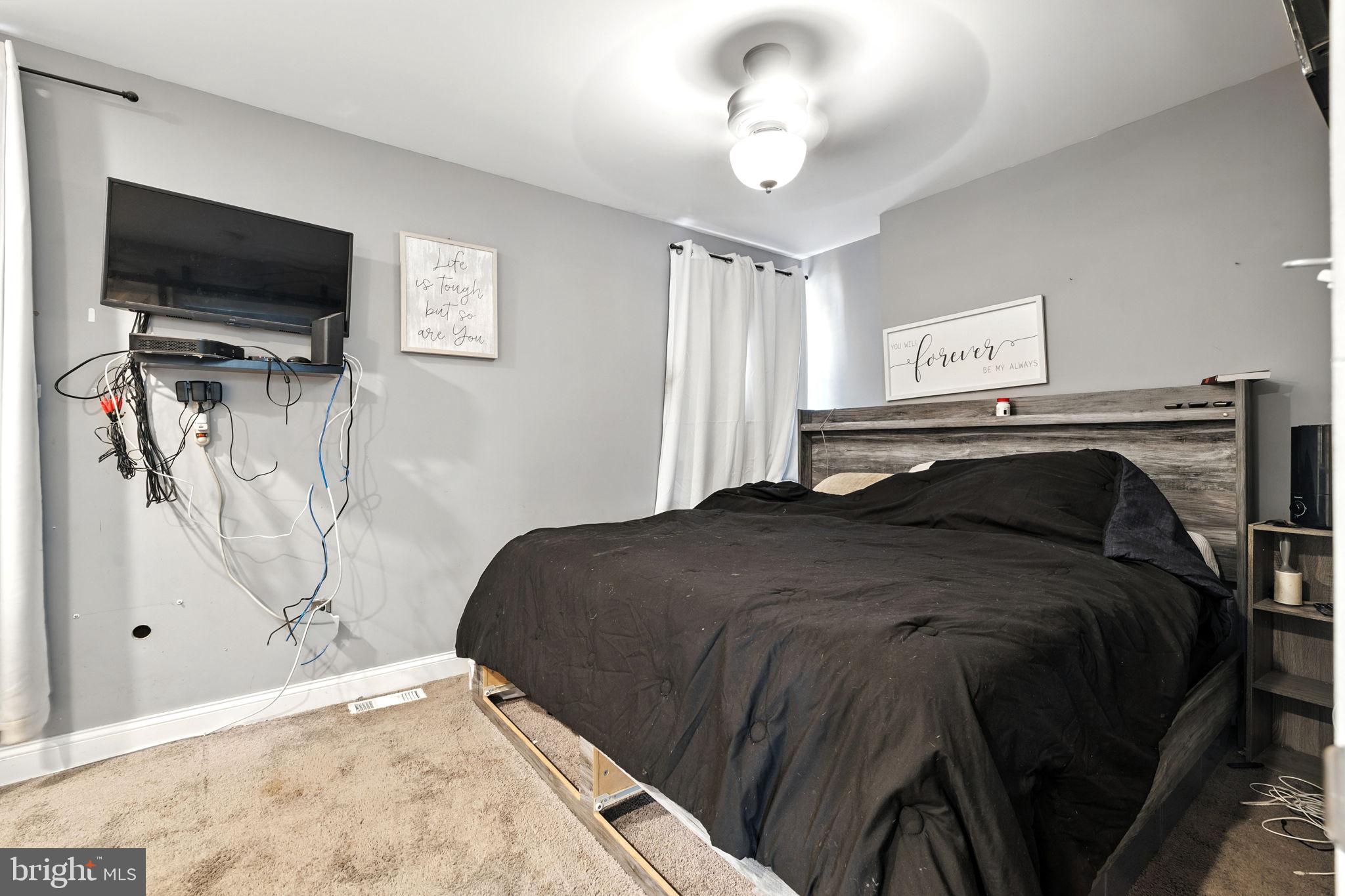 361 Savannah Road Baltimore, MD 21221 - Photo 6 of 30 a bedroom with a bed and a flat screen tv