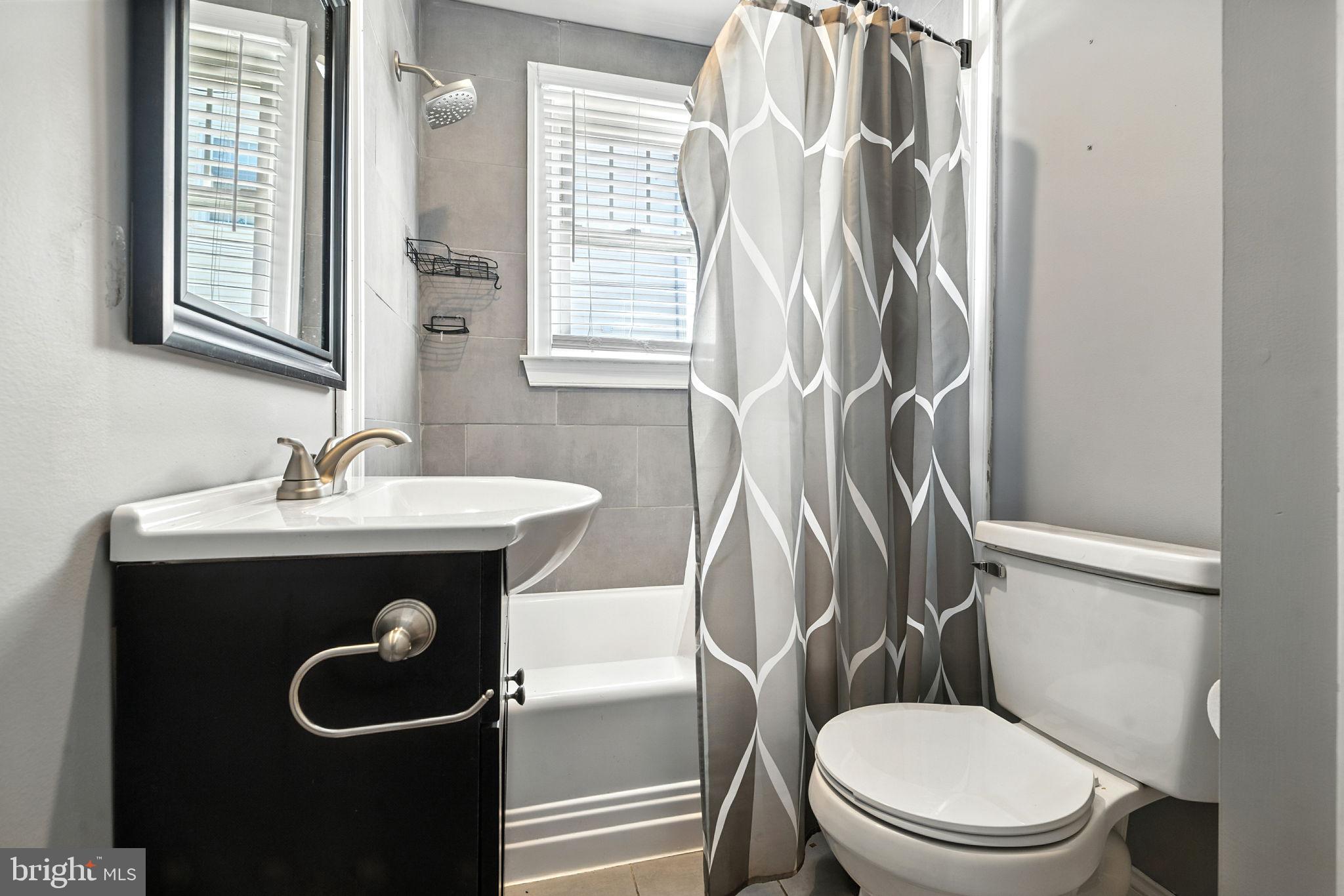 361 Savannah Road Baltimore, MD 21221 - Photo 10 of 30 a bathroom with a toilet sink and mirror