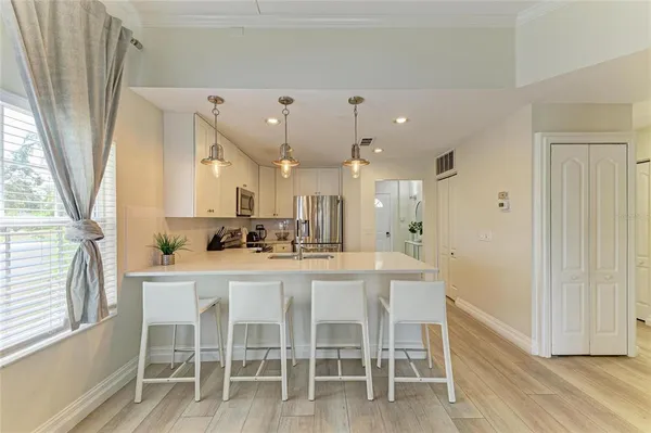 a kitchen with a sink a counter top space and cabinets