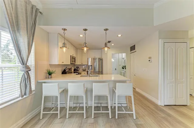 a kitchen with a sink a counter top space and cabinets