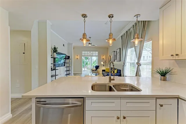 a kitchen with stainless steel appliances granite countertop a refrigerator sink and stove