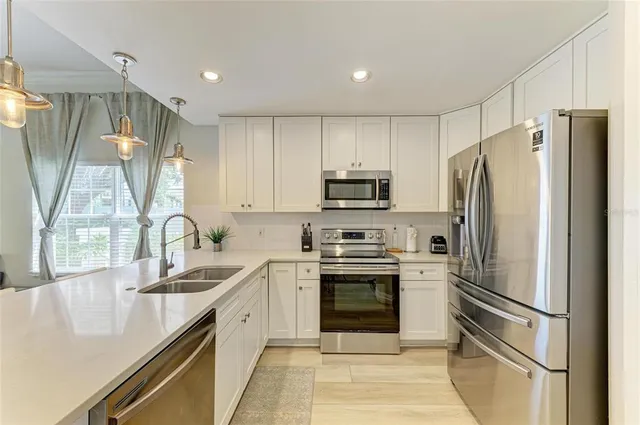 a large kitchen with a table and chairs