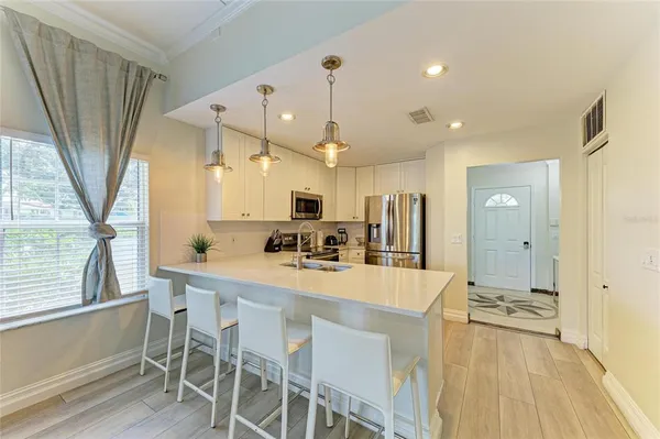a kitchen with a table and chairs in it