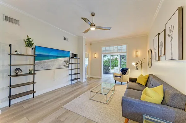 a living room with furniture and a wooden floor