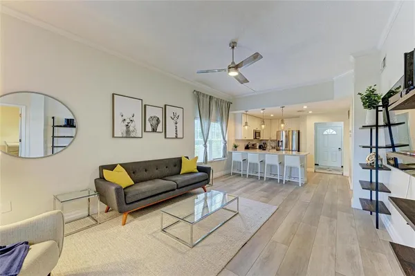a view of a dining room with furniture large windows and wooden floor