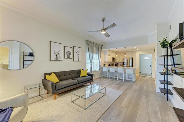 a view of a dining room with furniture large windows and wooden floor