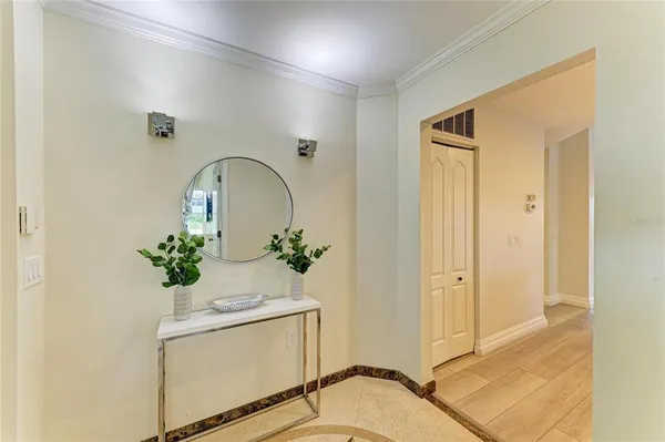a view of a hallway with wooden floor and a bathroom