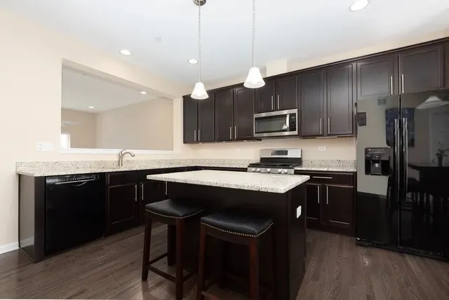 a kitchen with a sink cabinets and stainless steel appliances