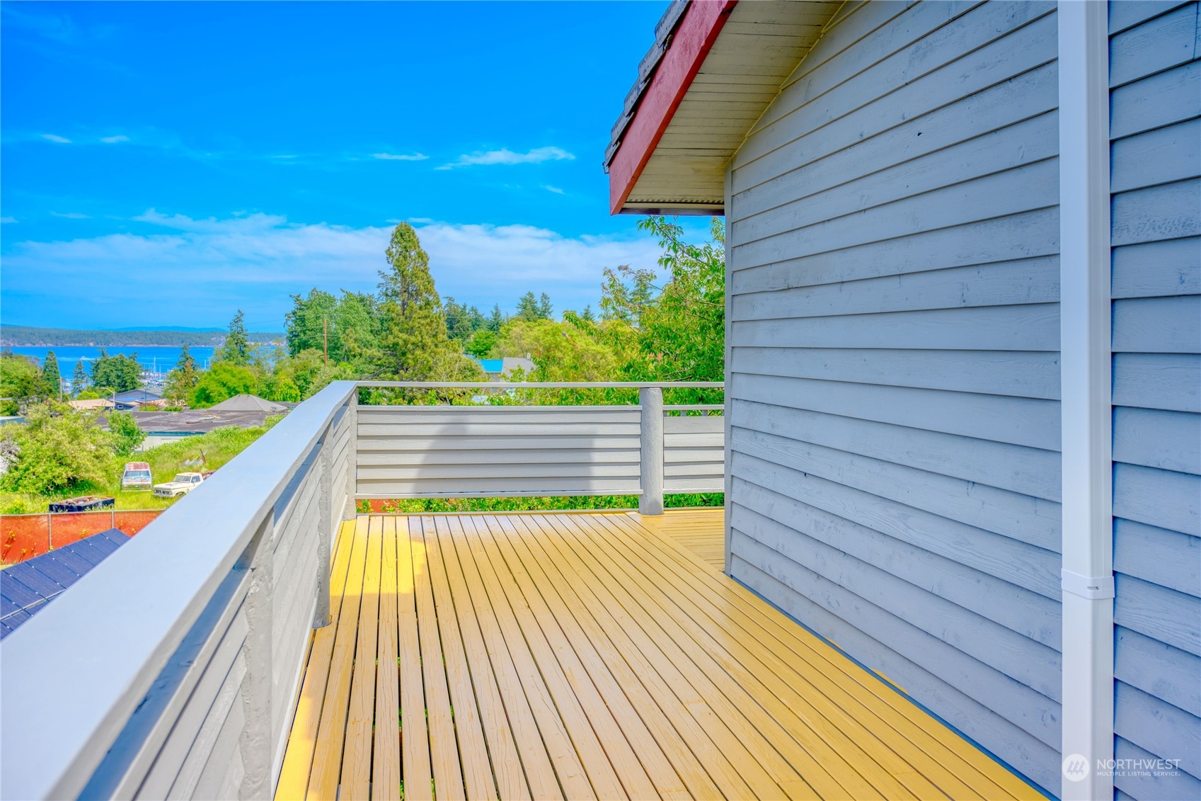 720 Guard Street, Unit 4 Friday Harbor, WA 98250 - Photo 1 of 19 a view of balcony with wooden floor and fence
