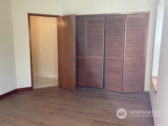 720 Guard Street, Unit 4 Friday Harbor, WA 98250 - Photo 14 of 19 an empty room with wooden floor and entrance door