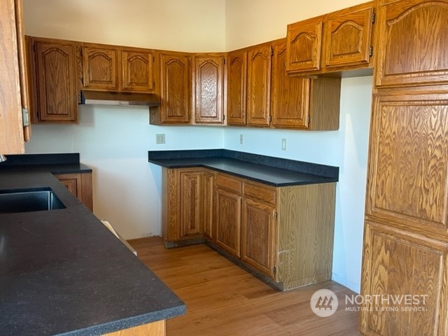 720 Guard Street, Unit 4 Friday Harbor, WA 98250 - Photo 5 of 19 a kitchen with stainless steel appliances granite countertop a refrigerator and cabinets
