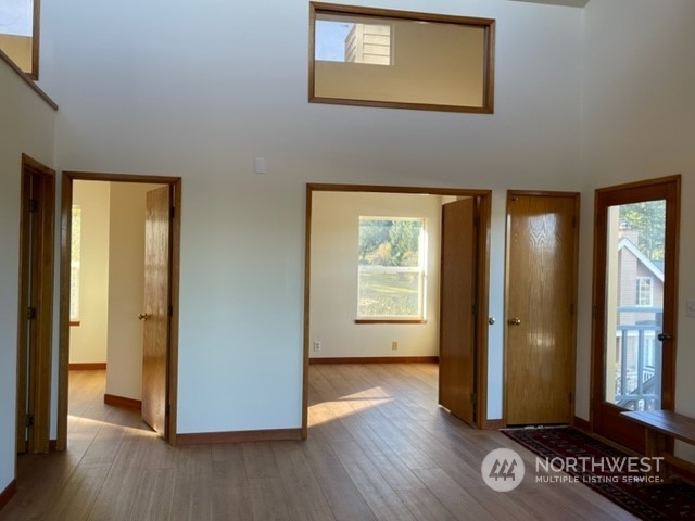 720 Guard Street, Unit 4 Friday Harbor, WA 98250 - Photo 6 of 19 an empty room with wooden floor and a window