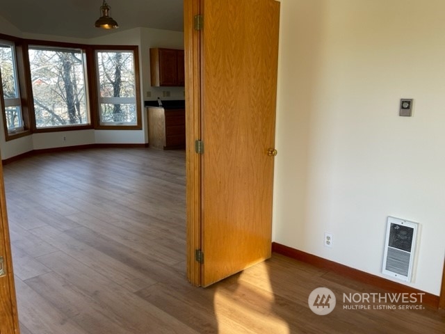 720 Guard Street, Unit 4 Friday Harbor, WA 98250 - Photo 9 of 19 an empty room with wooden floor and windows