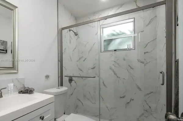 a bathroom with a sink toilet and shower