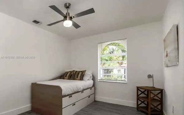 a bedroom with a bed and a window