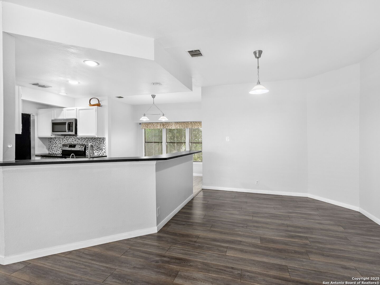 5430 Vista Court San Antonio, TX 78247 - Photo 12 of 37 a view of kitchen with stainless steel appliances granite countertop a refrigerator a sink a stove and white cabinets with wooden floor