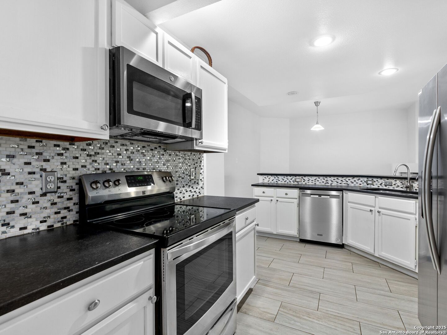 5430 Vista Court San Antonio, TX 78247 - Photo 17 of 37 a kitchen with granite countertop a stove sink and microwave
