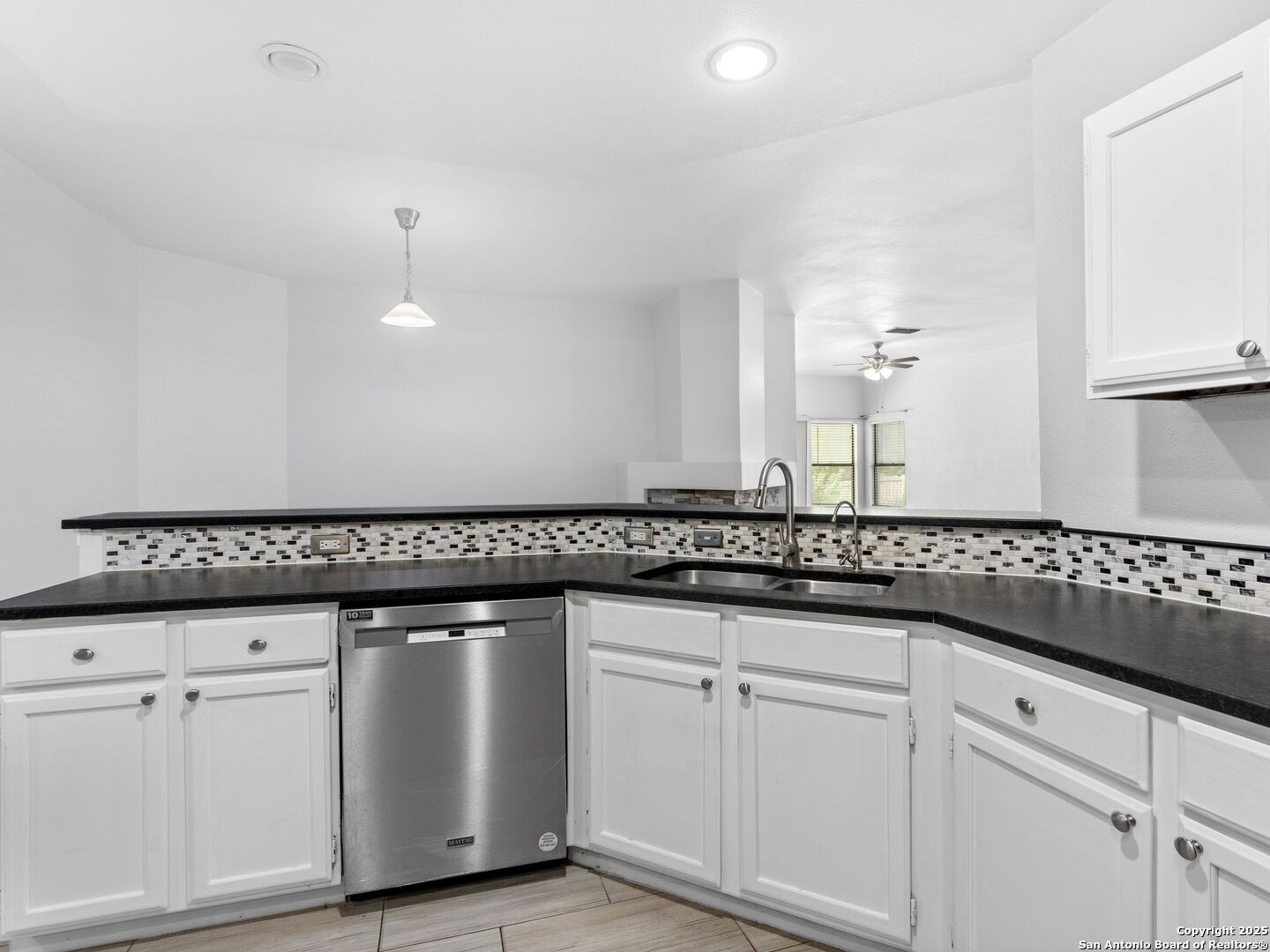 5430 Vista Court San Antonio, TX 78247 - Photo 18 of 37 a kitchen with granite countertop white cabinets and a sink
