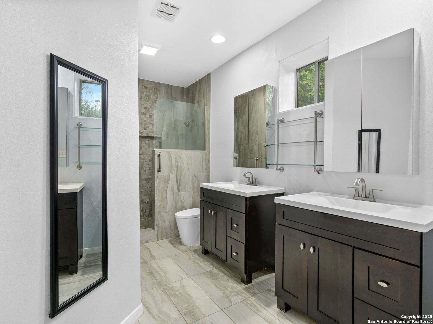 5430 Vista Court San Antonio, TX 78247 - Photo 26 of 37 a bathroom with a double vanity sink and mirror