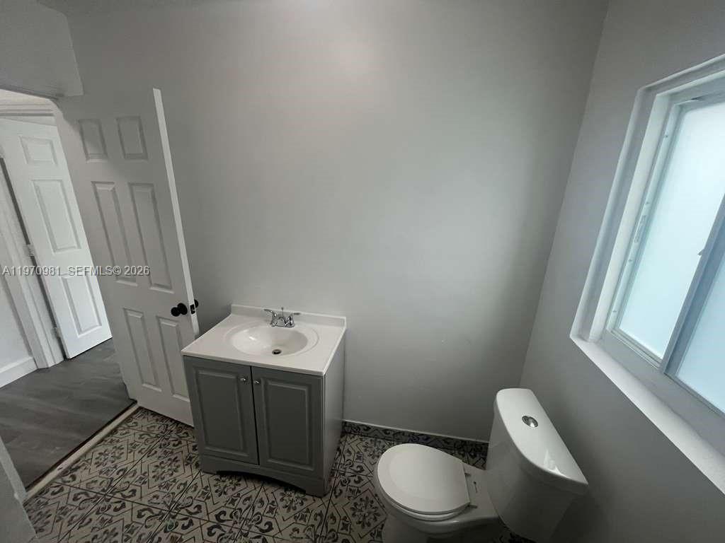 2758 Southwest 3rd Street Miami, FL 33135 - Photo 11 of 19 a bathroom with a toilet sink and mirror