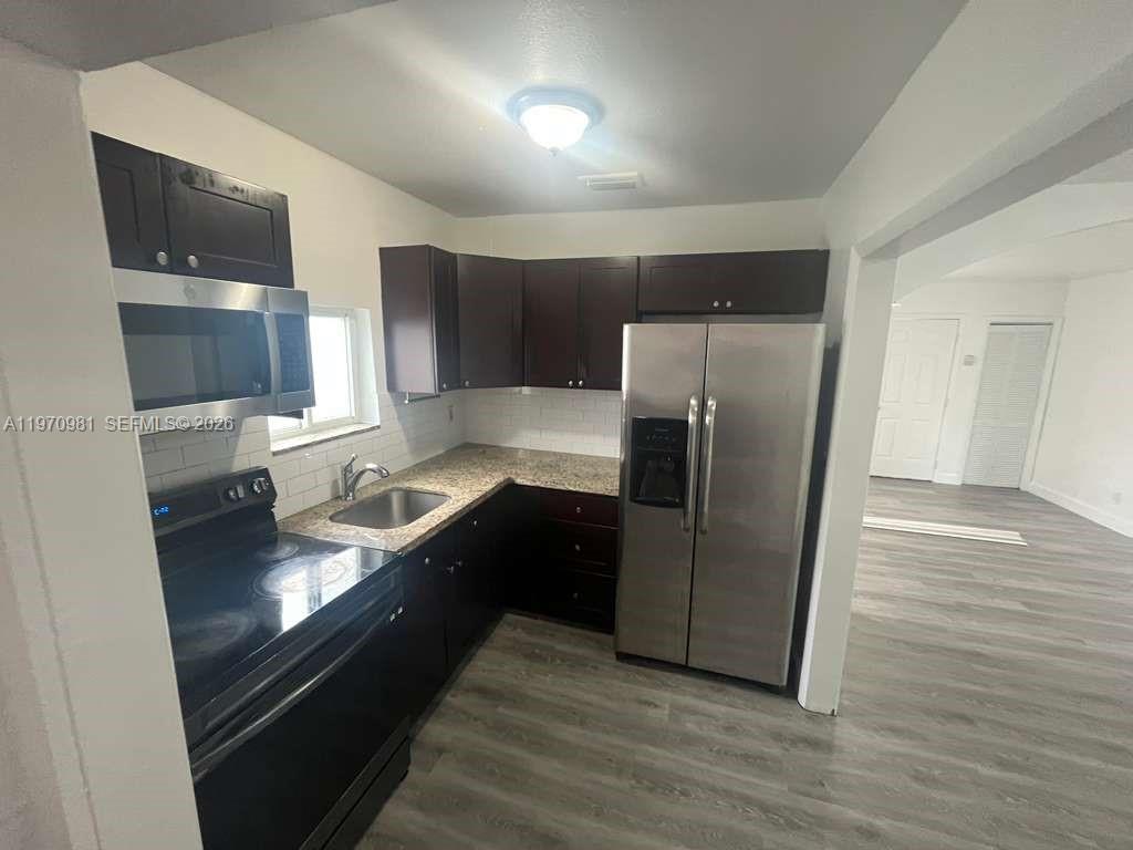 2758 Southwest 3rd Street Miami, FL 33135 - Photo 14 of 19 a kitchen with granite countertop a refrigerator and a sink