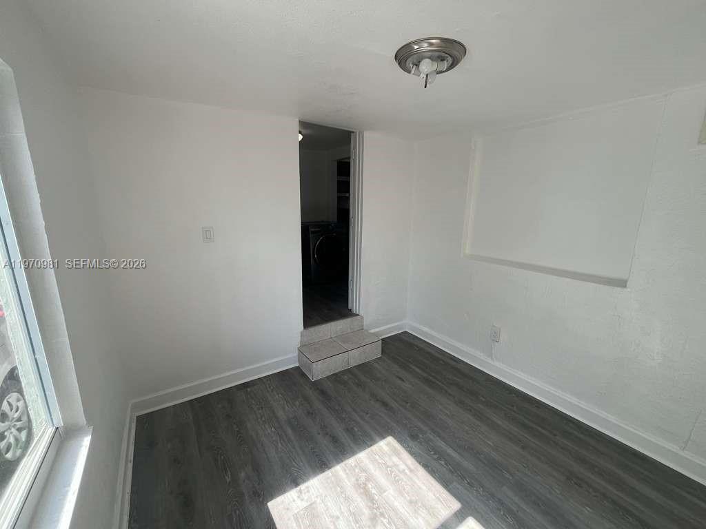 2758 Southwest 3rd Street Miami, FL 33135 - Photo 15 of 19 an empty room with wooden floor and windows