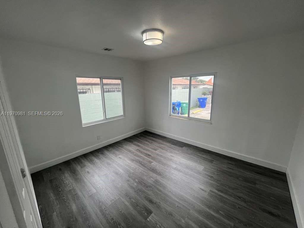 2758 Southwest 3rd Street Miami, FL 33135 - Photo 4 of 19 an empty room with wooden floor and windows