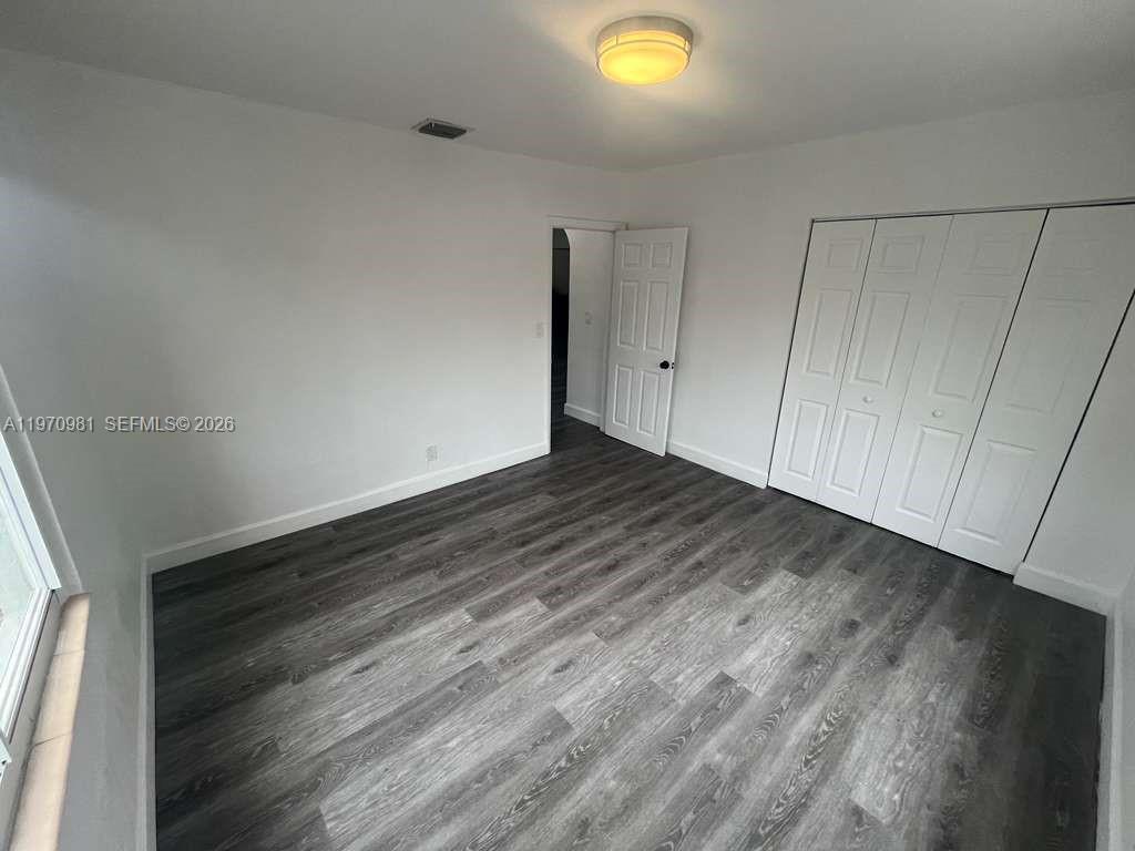 2758 Southwest 3rd Street Miami, FL 33135 - Photo 7 of 19 a view of an empty room with wooden floor and entryway