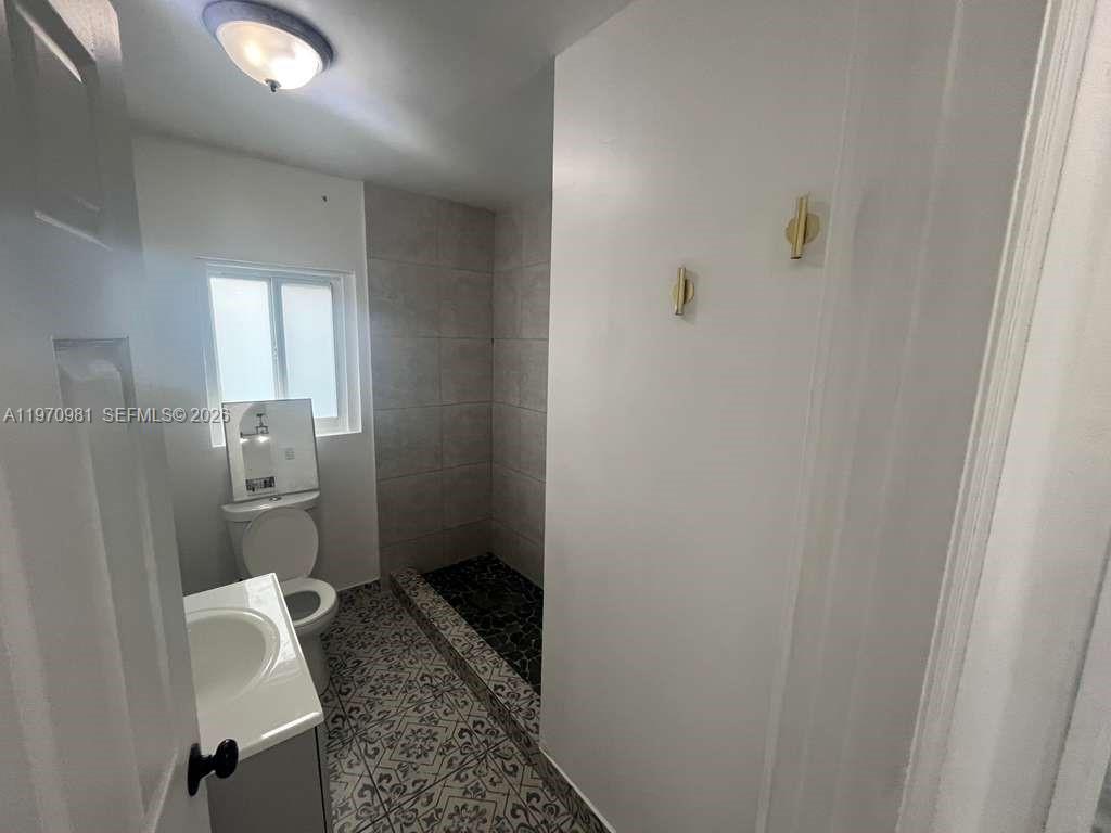 2758 Southwest 3rd Street Miami, FL 33135 - Photo 9 of 19 a bathroom with a granite countertop toilet and a sink