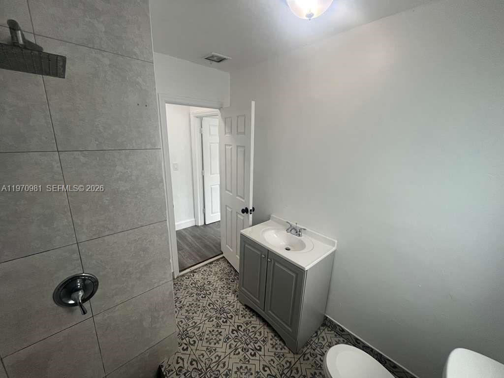 2758 Southwest 3rd Street Miami, FL 33135 - Photo 10 of 19 a bathroom with a toilet sink and mirror