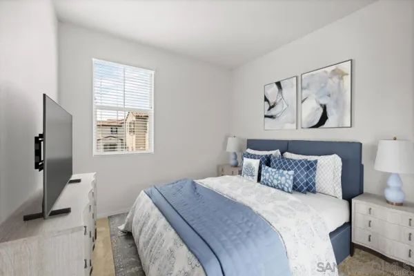 a bedroom with a bed and a window
