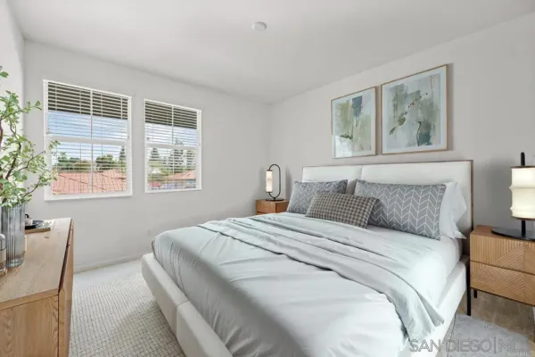 a bedroom with a large bed and a window