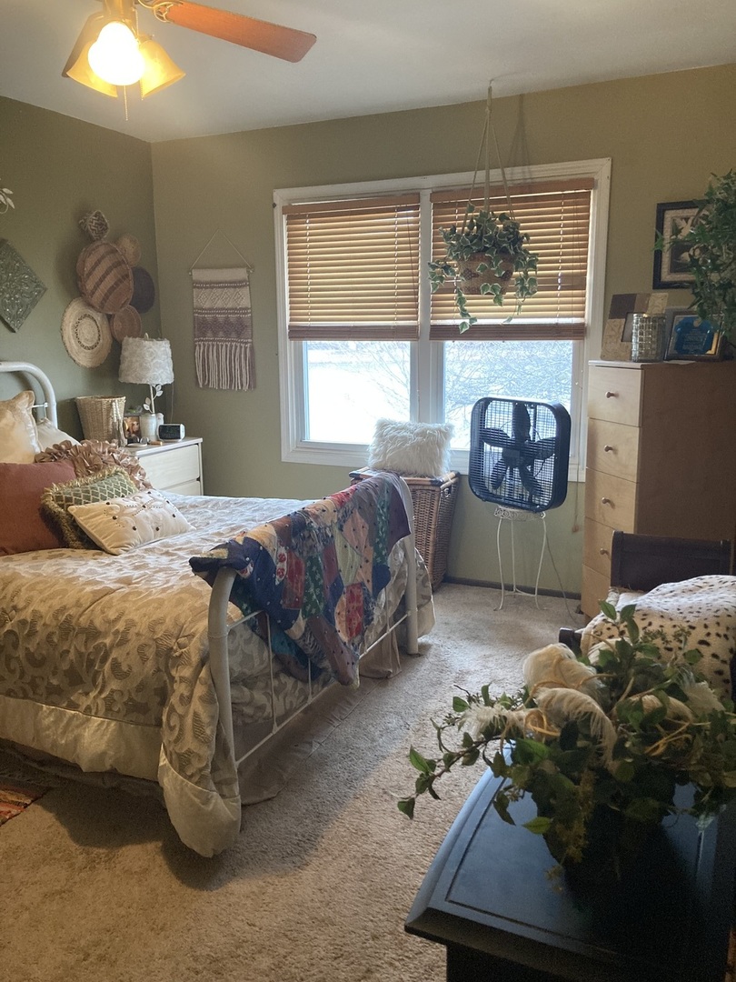 1463 Elder Drive Aurora, IL 60506 - Photo 17 of 32 a bedroom with a bed and a fireplace