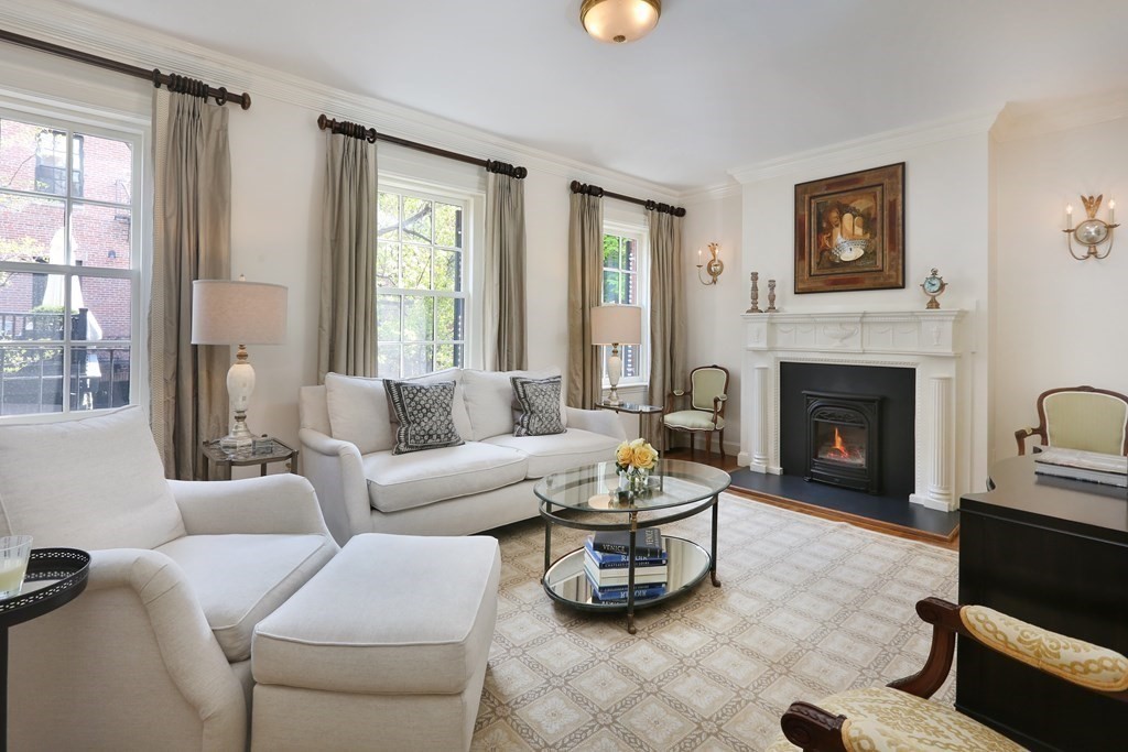 44 Cedar Ln Way Boston, MA 02114 - Photo 1 of 17 a living room with furniture and a fireplace