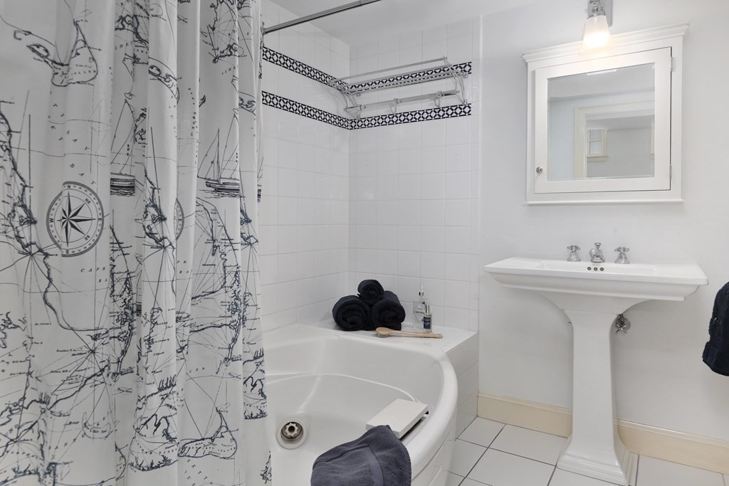 44 Cedar Ln Way Boston, MA 02114 - Photo 12 of 17 a bathroom with a sink and a mirror