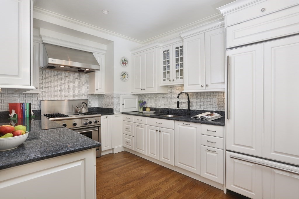 44 Cedar Ln Way Boston, MA 02114 - Photo 4 of 17 a kitchen with stainless steel appliances granite countertop a sink stove and cabinets