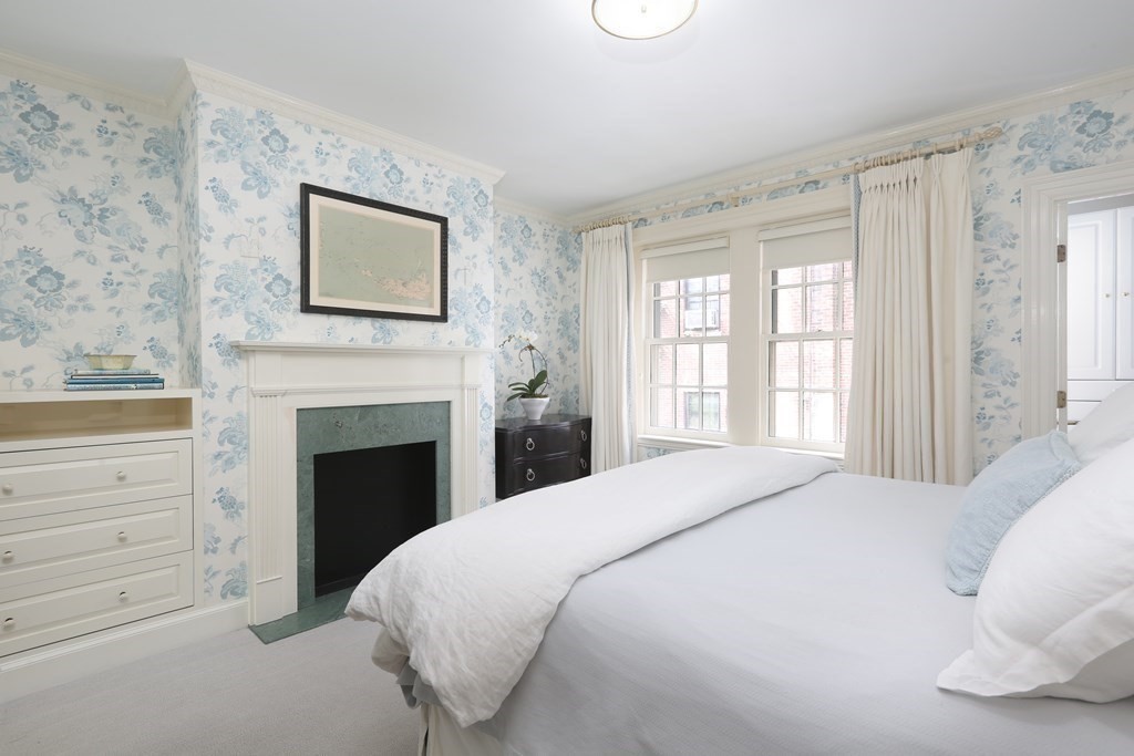 44 Cedar Ln Way Boston, MA 02114 - Photo 6 of 17 a bedroom with a bed and a fireplace