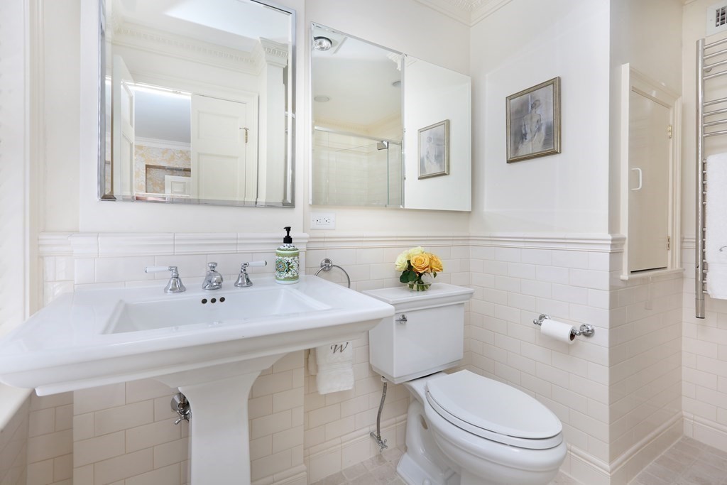 44 Cedar Ln Way Boston, MA 02114 - Photo 9 of 17 a bathroom with a sink mirror vanity and toilet