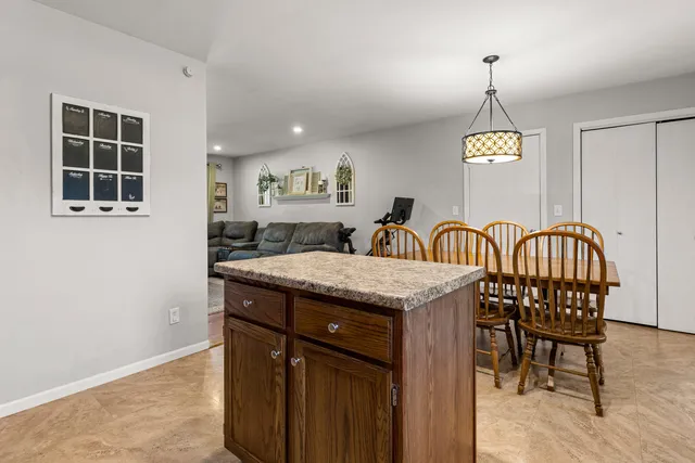 a view of a kitchen area with granite countertop furniture and window